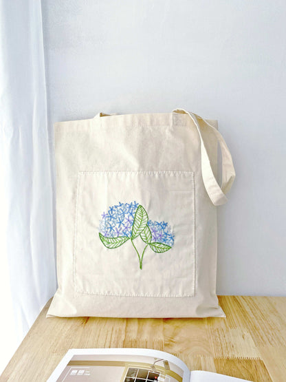 natural material tote bag with unique hand embroidered art