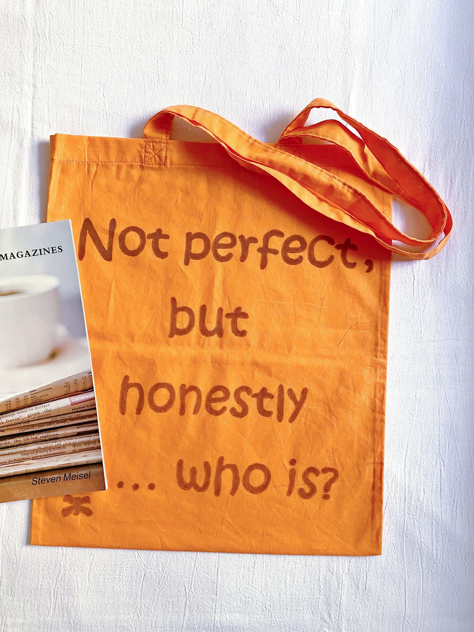eco friendly orange bag showing a relaxed handwritten text element