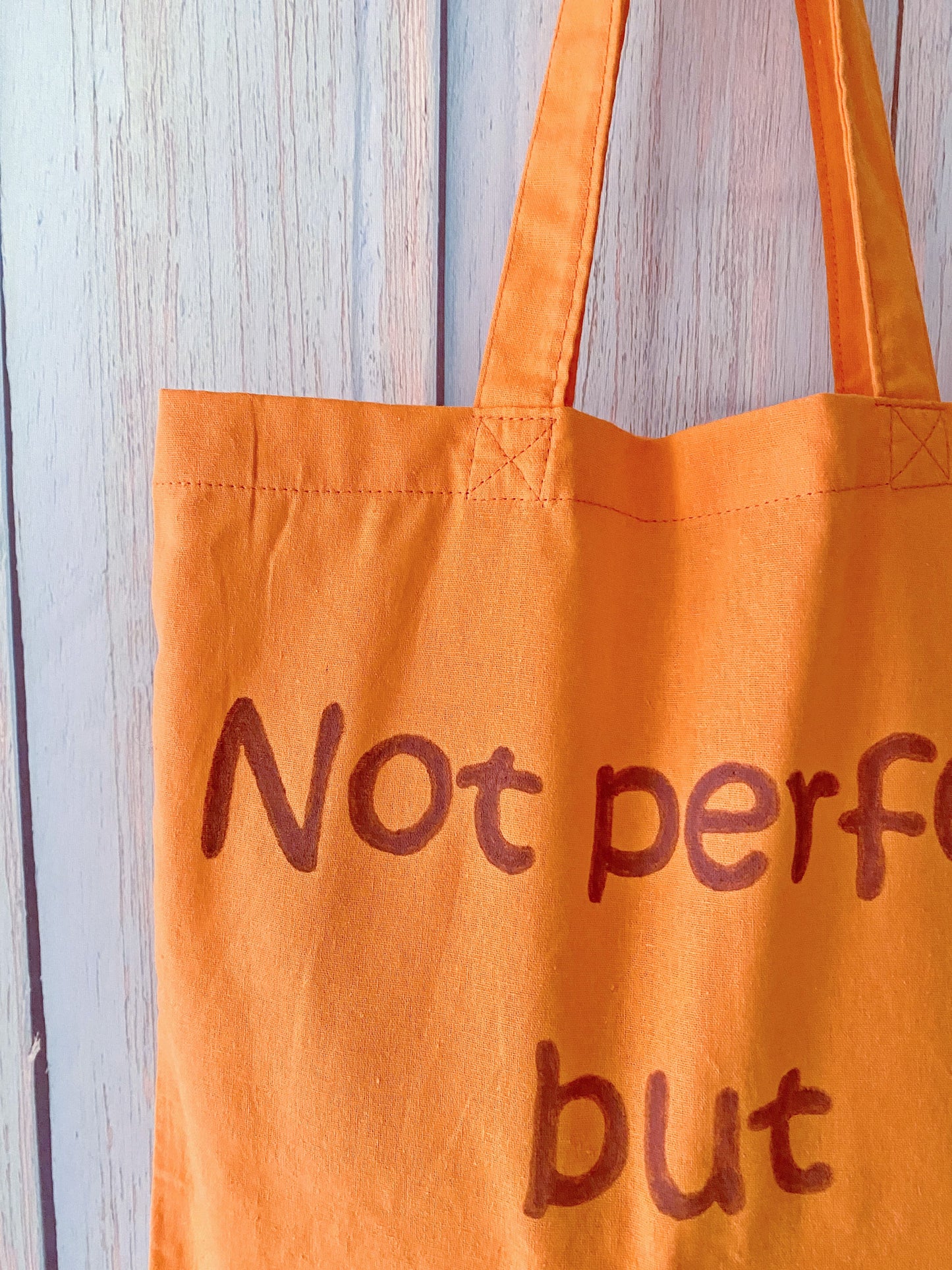 relaxed orange bag for people searching for soft totes with text art