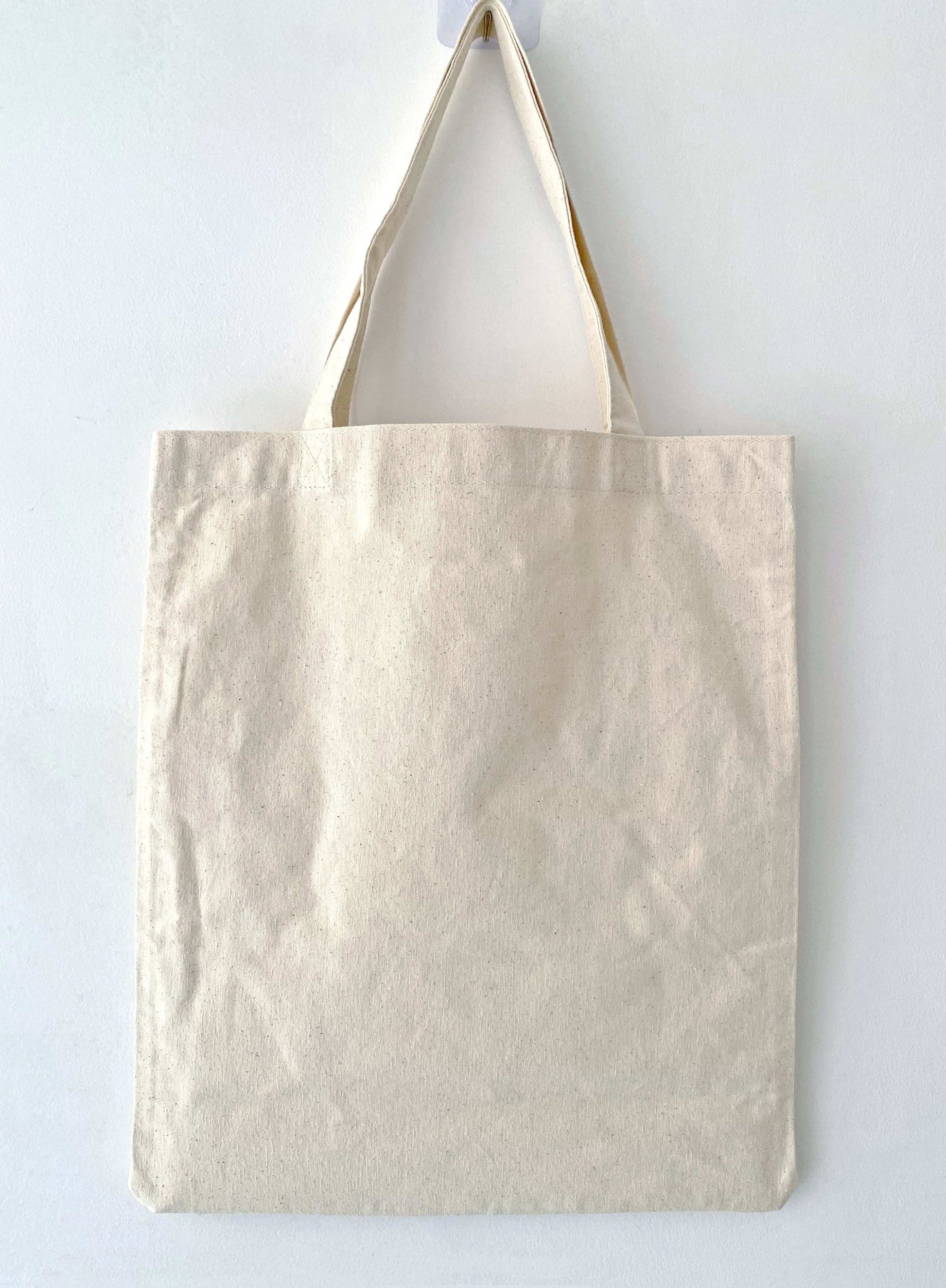 Eco-conscious cotton shoulder bag with handcrafted embroidery design