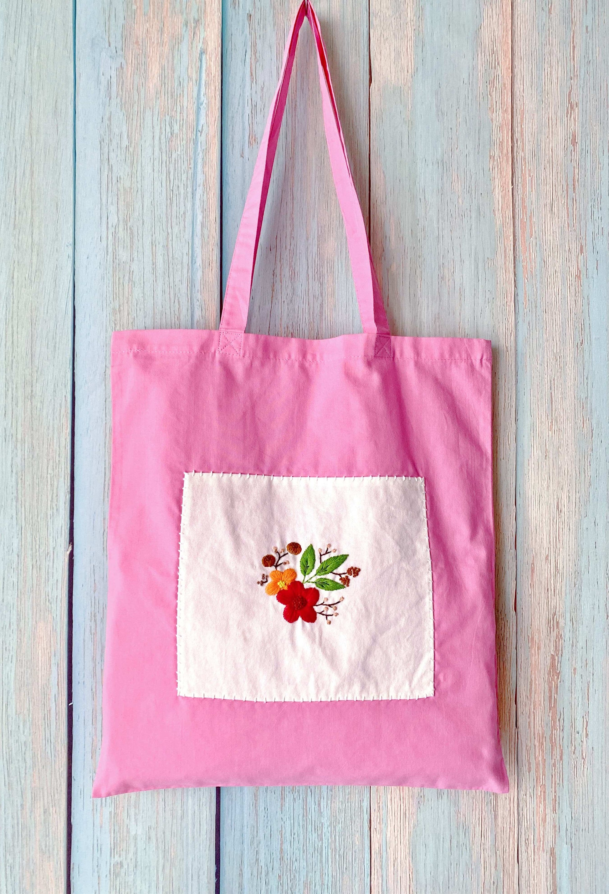 Sustainable cotton tote bag with artistic floral hand embroidery, perfect for minimalist and eco-conscious lifestyles.