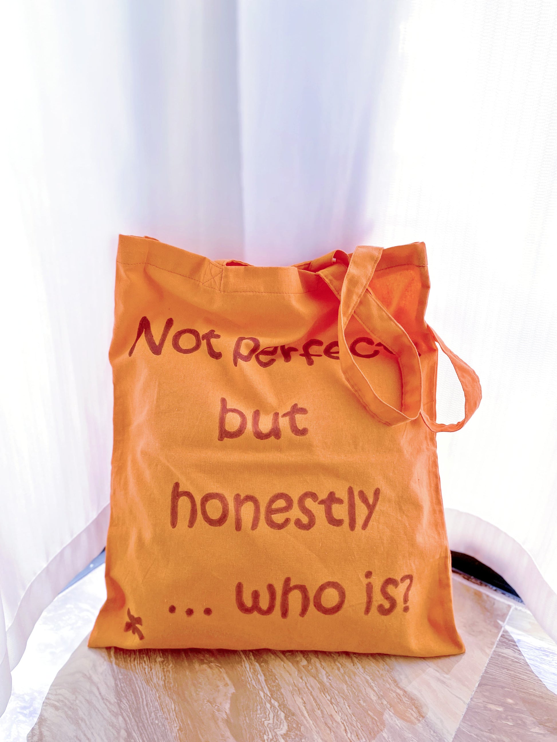 orange shoulder tote highlighted by an English short phrase feature