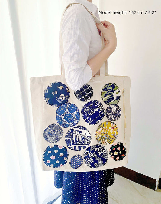 Spacious shoulder tote from cotton, highlighting artisanal stitched motifs for personalized style