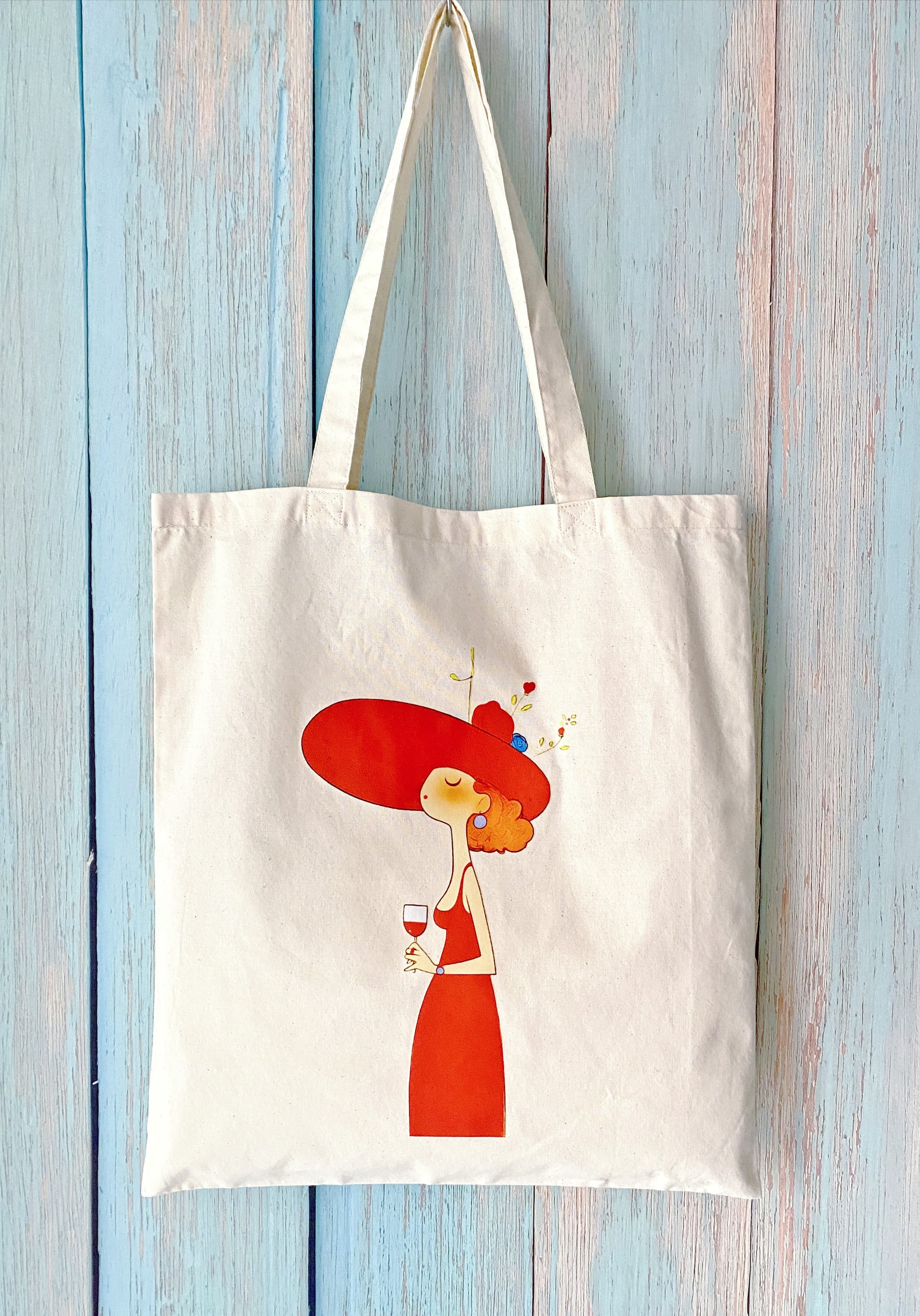 Eco-friendly cotton tote bag with a hand-printed woman holding a wine glass design, ideal for minimalists and slow living lovers in Paris or Milan.