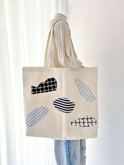 Unique patchwork design tote bag crafted from sustainable cotton canvas