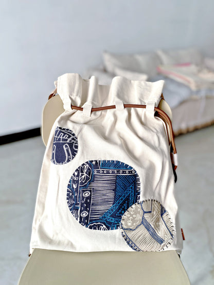 Sustainable canvas backpack gift idea with creative patchwork art, ideal for travel or school