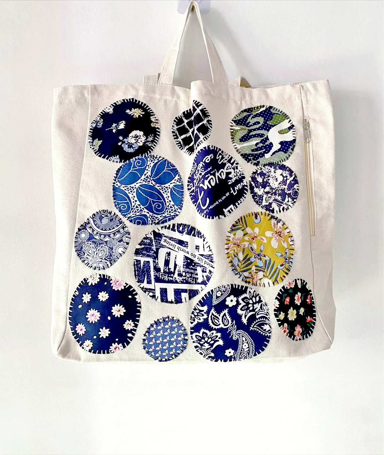 Sustainable women's bag with roomy interior and hand-sewn patchwork accents in earthy colors