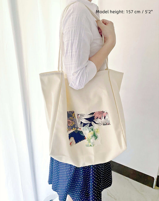 Versatile canvas bag with handmade patchwork motifs, designed for large storage and eco-friendly appeal in modern lifestyles