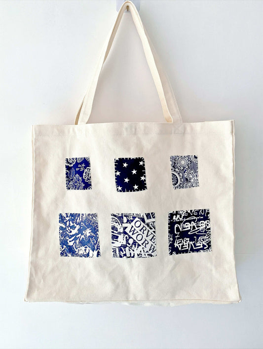 Spacious women's canvas tote bag with durable natural fabric and unique handmade patchwork accents for everyday eco-conscious style.